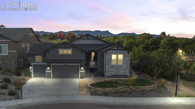 craftsman house with a mountain view and a garage