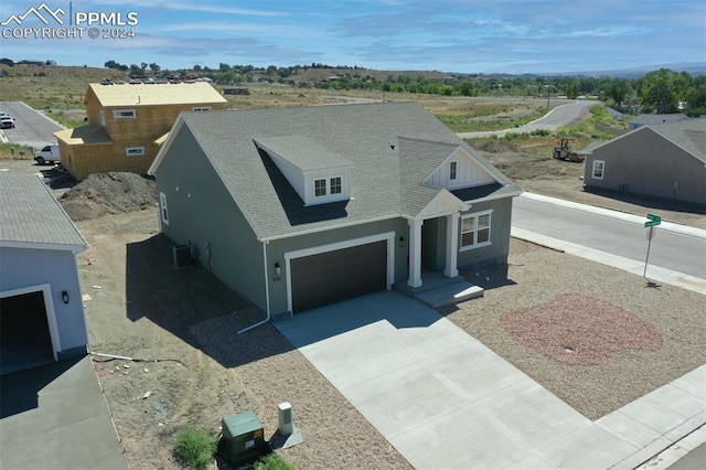 view of front facade featuring central AC and a garage