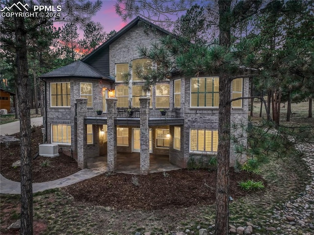 view of front of house featuring a patio area and a balcony