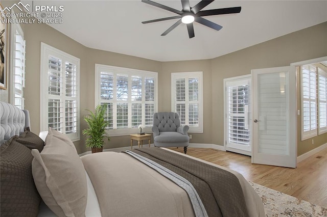 bedroom featuring access to outside, multiple windows, ceiling fan, and light hardwood / wood-style flooring