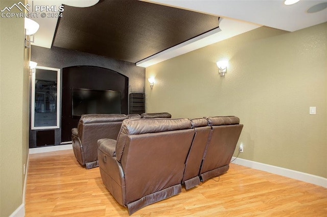 cinema room with light hardwood / wood-style floors