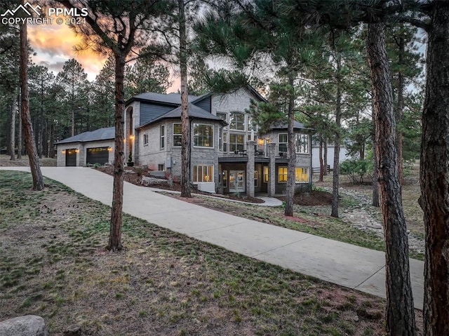 view of front of house with a garage and a balcony