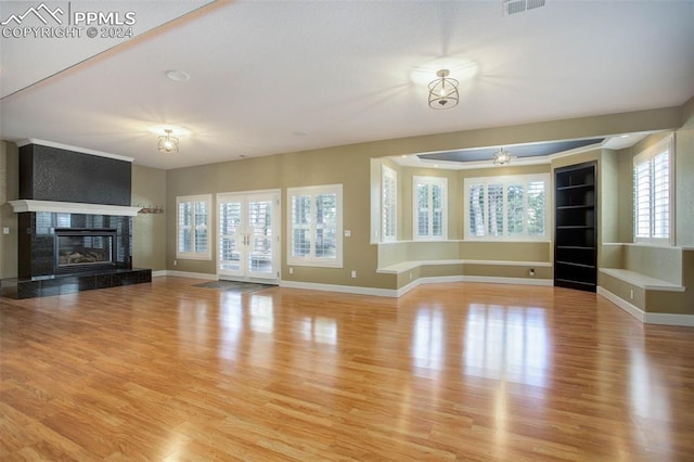 unfurnished living room with a fireplace and light wood-type flooring