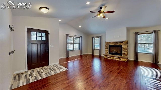 entrance foyer featuring a fireplace, wood-type flooring, vaulted ceiling, and plenty of natural light