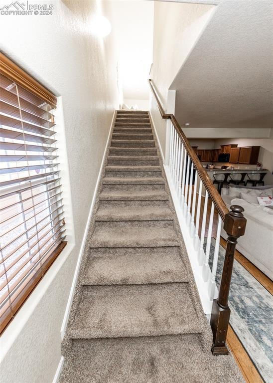 1441 Kempton Aly, Colorado Springs, CO 80910 - stairway with baseboards and a textured wall