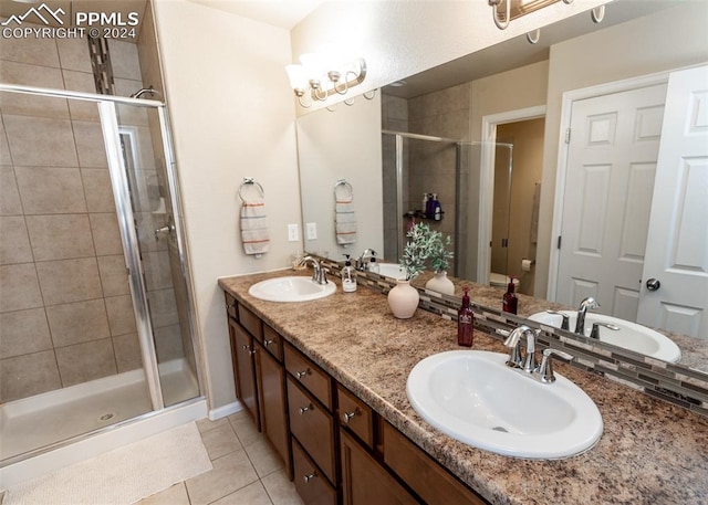 1441 Kempton Aly, Colorado Springs, CO 80910 - bathroom featuring tile patterned flooring, a stall shower, double vanity, baseboards, and toilet