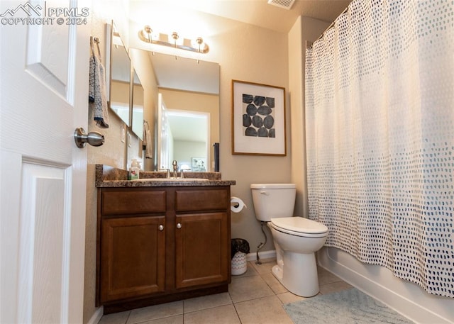 1441 Kempton Aly, Colorado Springs, CO 80910 - full bathroom with tile patterned floors, vanity, toilet, and baseboards