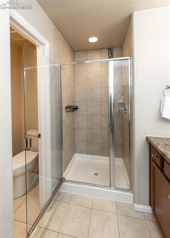 1441 Kempton Aly, Colorado Springs, CO 80910 - bathroom with toilet, a stall shower, vanity, tile patterned flooring, and recessed lighting