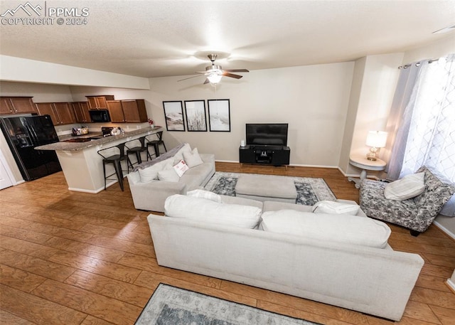 1441 Kempton Aly, Colorado Springs, CO 80910 - living room with a ceiling fan, light wood-style flooring, and baseboards