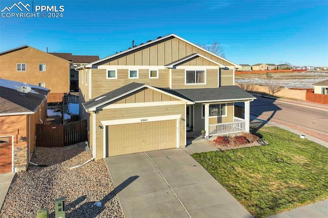 view of front of property featuring a porch and a garage