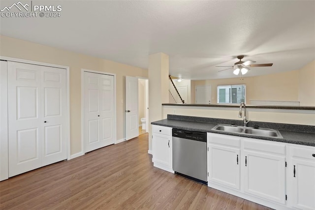 kitchen with ceiling fan, sink, stainless steel dishwasher, light hardwood / wood-style floors, and white cabinets