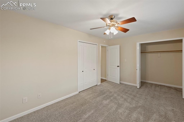 unfurnished bedroom featuring ceiling fan and light colored carpet