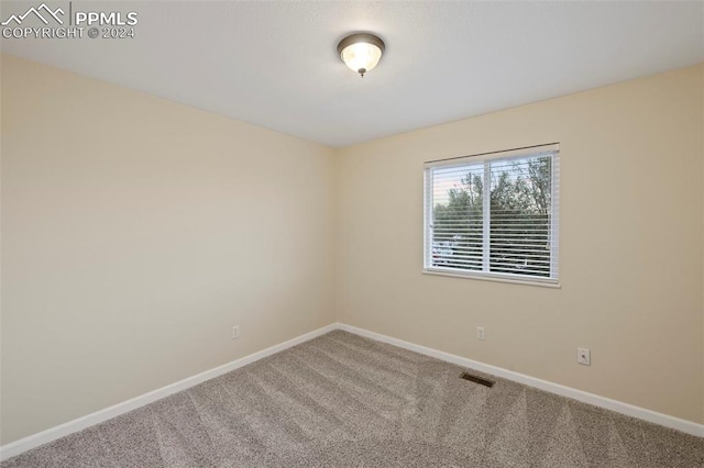 unfurnished room featuring carpet flooring