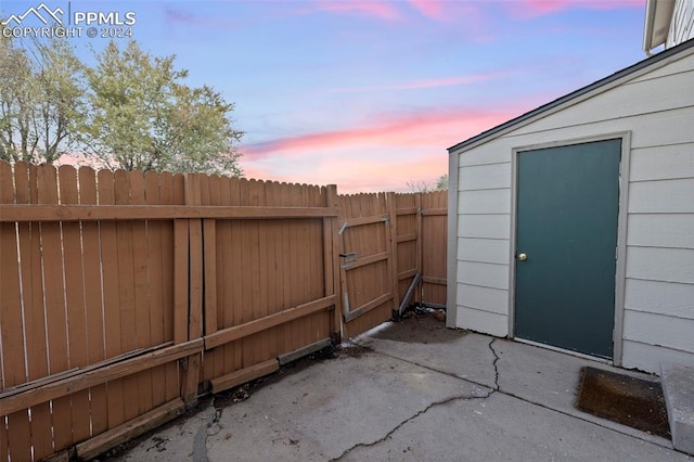 patio terrace at dusk with a storage unit