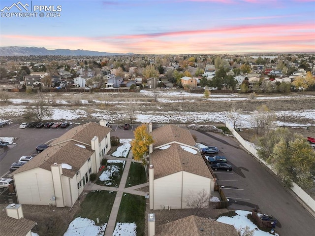 snowy aerial view featuring a mountain view