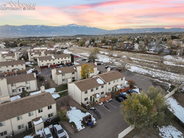 snowy aerial view with a mountain view