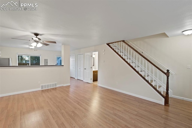 unfurnished living room with ceiling fan and light wood-type flooring