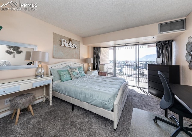 carpeted bedroom featuring a textured ceiling and access to outside