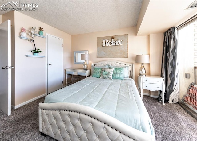 carpeted bedroom featuring a textured ceiling