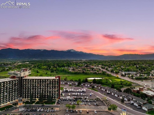 aerial view at dusk featuring a mountain view