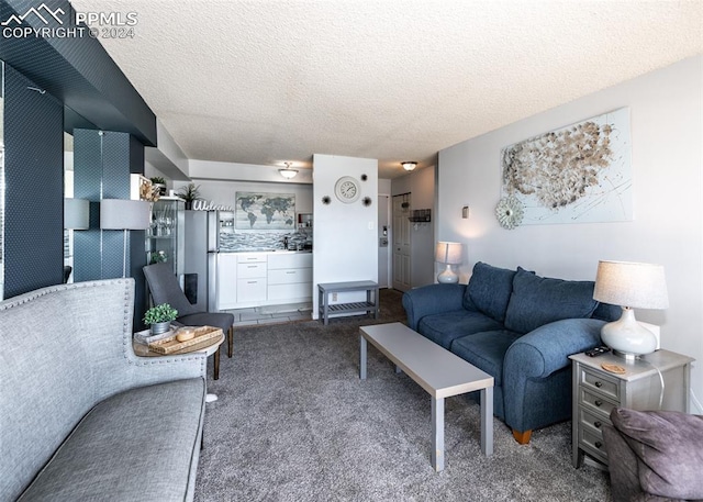 carpeted living room featuring a textured ceiling