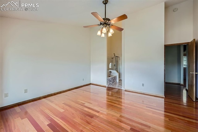 empty room featuring hardwood / wood-style flooring and ceiling fan