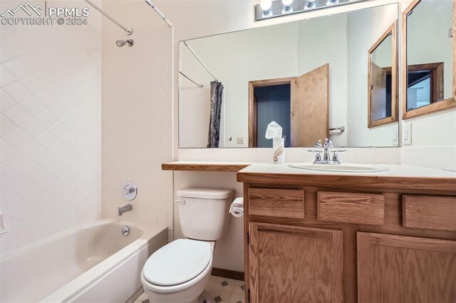 full bathroom featuring vanity, shower / tub combo, and toilet