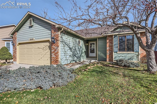 single story home with a front yard and a garage