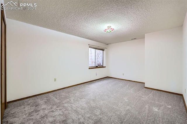 unfurnished room featuring a textured ceiling and carpet floors