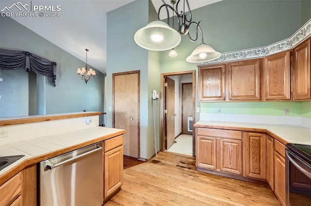 kitchen featuring stainless steel dishwasher, black range with electric cooktop, pendant lighting, light hardwood / wood-style flooring, and a chandelier