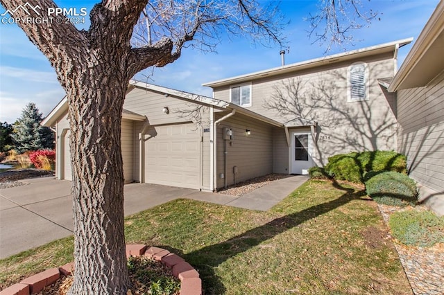 view of front of property with a garage and a front yard