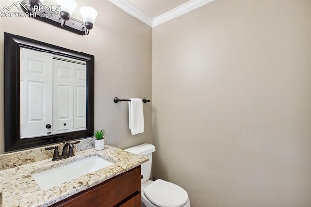 bathroom featuring crown molding, vanity, and toilet