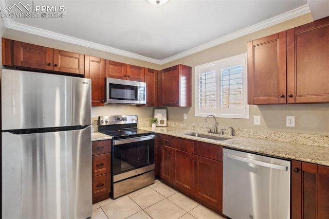 kitchen with sink, stainless steel appliances, light stone counters, light tile patterned floors, and ornamental molding