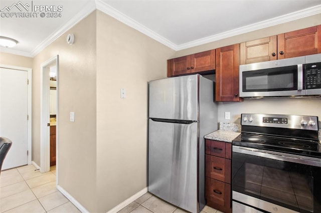 kitchen featuring light tile patterned floors, stainless steel appliances, and ornamental molding