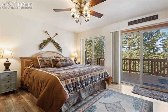 bedroom featuring access to exterior, light hardwood / wood-style floors, and multiple windows