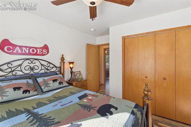 bedroom with a closet, hardwood / wood-style flooring, and ceiling fan