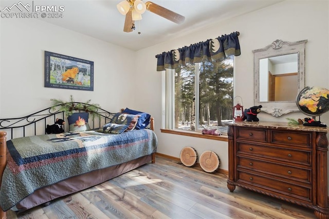 bedroom with light hardwood / wood-style flooring and ceiling fan