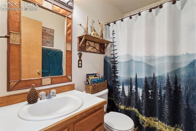 bathroom featuring vanity and toilet