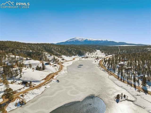 snowy aerial view featuring a mountain view