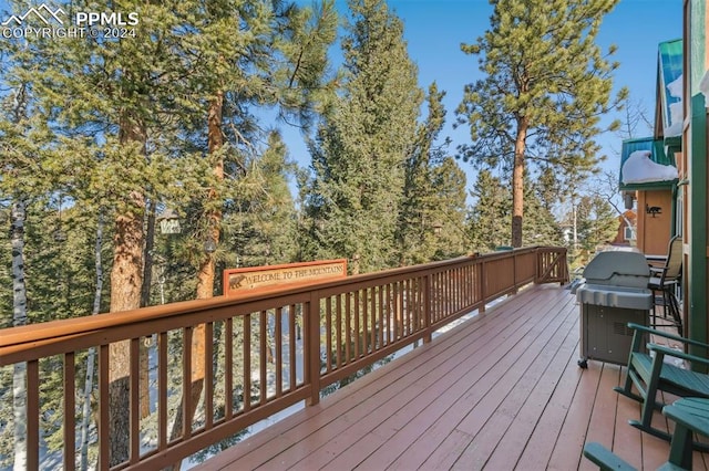 wooden terrace featuring a grill