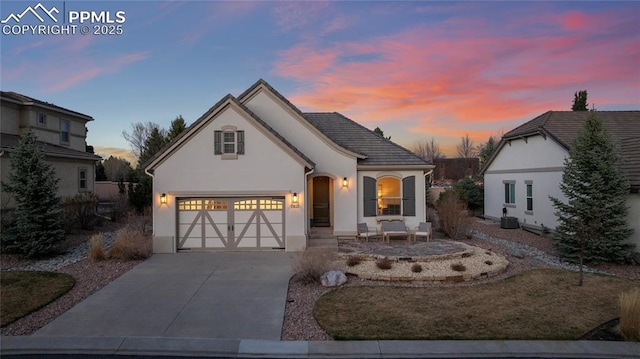 2933 Cathedral Park Vw, Colorado Springs, CO 80904 - view of front of home with concrete driveway, stucco siding, and a garage