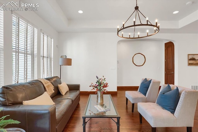2933 Cathedral Park Vw, Colorado Springs, CO 80904 - living room featuring arched walkways, wood finished floors, a raised ceiling, a chandelier, and recessed lighting