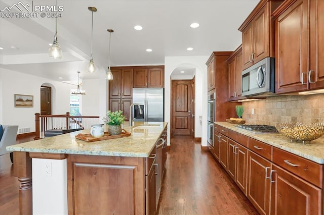 2933 Cathedral Park Vw, Colorado Springs, CO 80904 - kitchen featuring stainless steel appliances, arched walkways, a sink, decorative backsplash, and recessed lighting