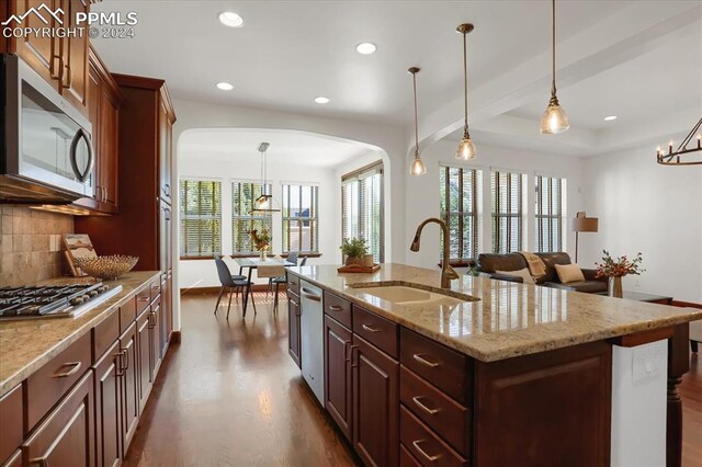 2933 Cathedral Park Vw, Colorado Springs, CO 80904 - kitchen featuring stainless steel appliances, a sink, arched walkways, dark wood finished floors, and recessed lighting