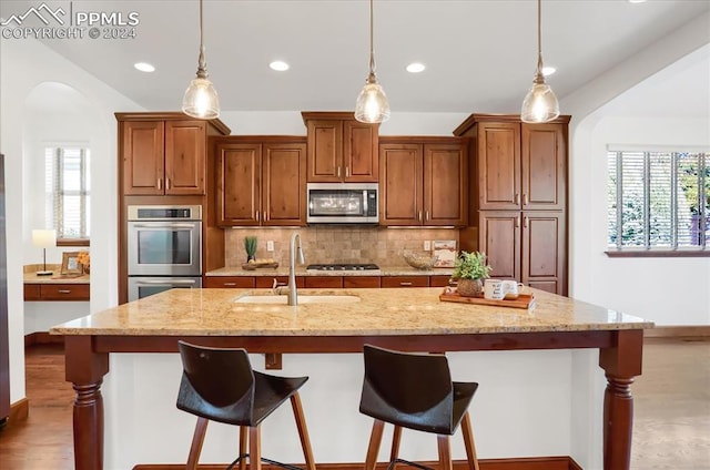 2933 Cathedral Park Vw, Colorado Springs, CO 80904 - kitchen with appliances with stainless steel finishes, arched walkways, a sink, decorative backsplash, and recessed lighting