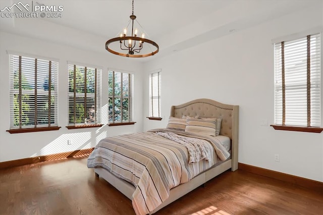 2933 Cathedral Park Vw, Colorado Springs, CO 80904 - bedroom with a chandelier, wood finished floors, and baseboards