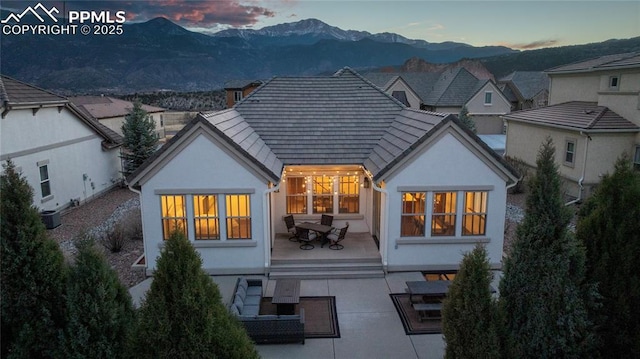 2933 Cathedral Park Vw, Colorado Springs, CO 80904 - rear view of property with a mountain view, a patio, and stucco siding