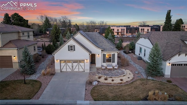 2933 Cathedral Park Vw, Colorado Springs, CO 80904 - view of front facade featuring concrete driveway, a garage, a residential view, stucco siding, and a tile roof