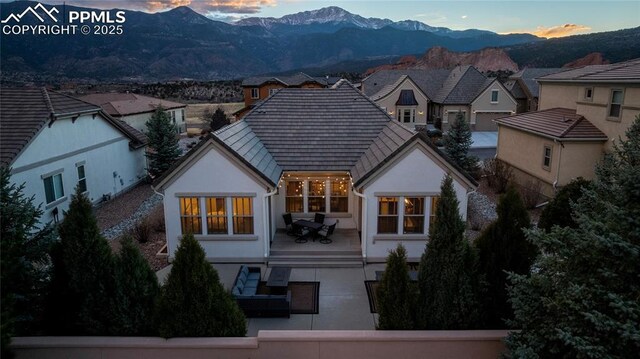 2933 Cathedral Park Vw, Colorado Springs, CO 80904 - back of house featuring a mountain view, stucco siding, and a patio area