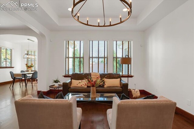 2933 Cathedral Park Vw, Colorado Springs, CO 80904 - living area with a chandelier, a tray ceiling, and plenty of natural light